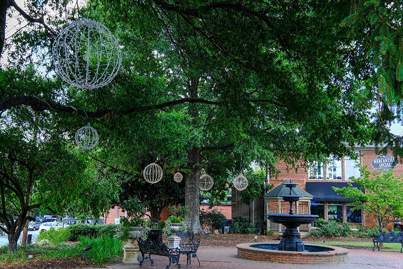 alpharetta histor district featuring asocial club a park a fountain and sitting are