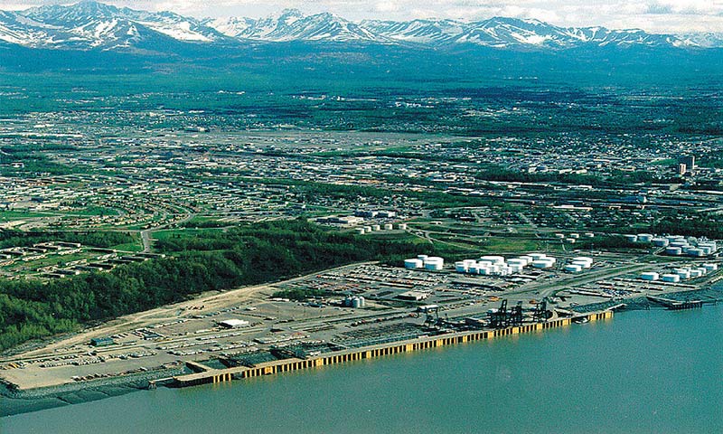 aerial view of a city in between water and mountains