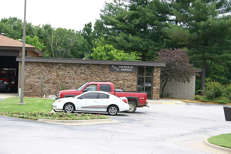 two cars parked in front of POA general office