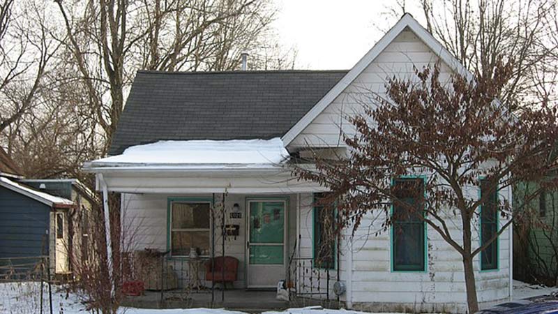 a white house with a gray roof in the historic district, bloomington