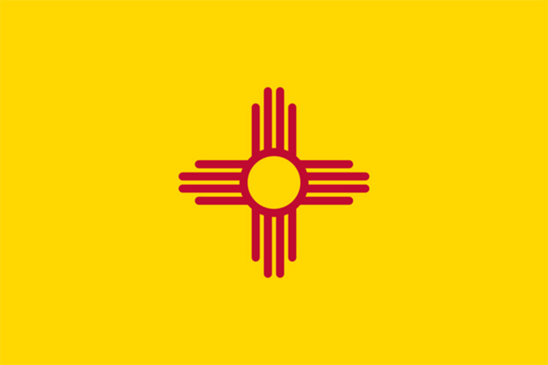 a yellow new mexico flag with a red cross