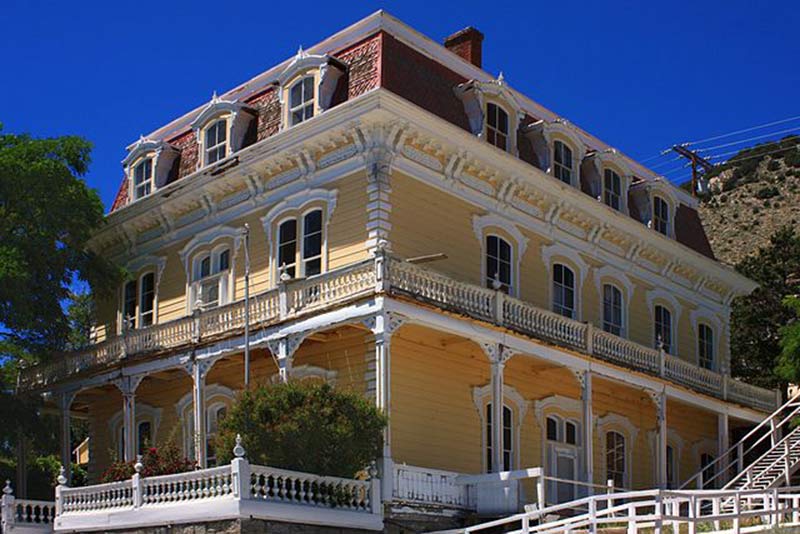 three floor mansion in yellow and white colors